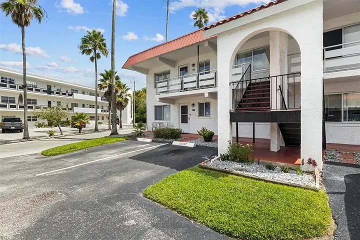 Arched stairwell entry with palms