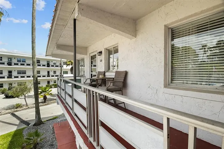 Covered balcony walkway with chairs